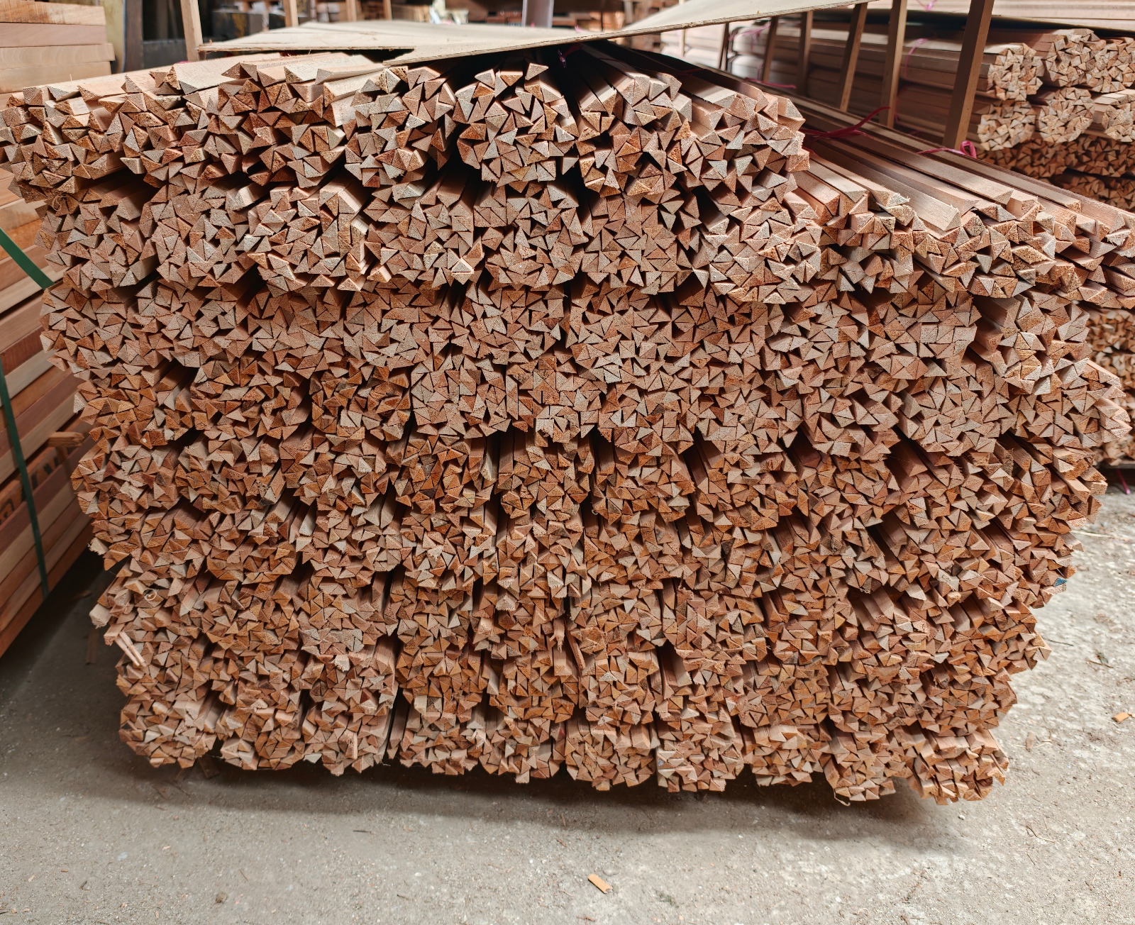 Stacked bundles of meranti beading in our warehouse, showing the triangular beading ends